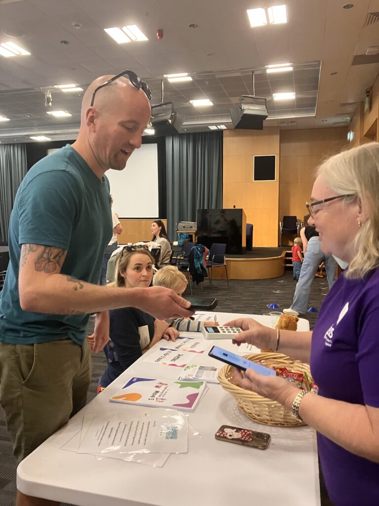 Man completing contactless payment to donate to EOS